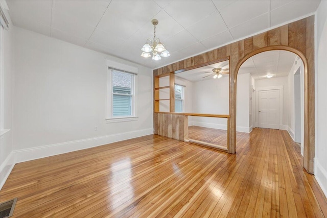 1132 Montrose Ave SE, Roanoke, VA 24013 - unfurnished room with arched walkways, light wood-type flooring, a chandelier, baseboards, and a ceiling fan