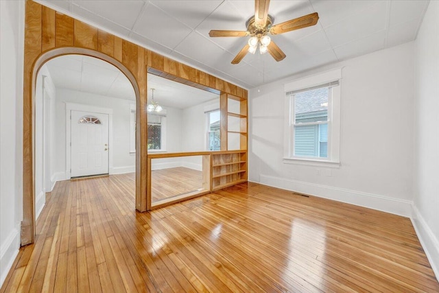 1132 Montrose Ave SE, Roanoke, VA 24013 - unfurnished room with light wood-type flooring, baseboards, a ceiling fan, and arched walkways