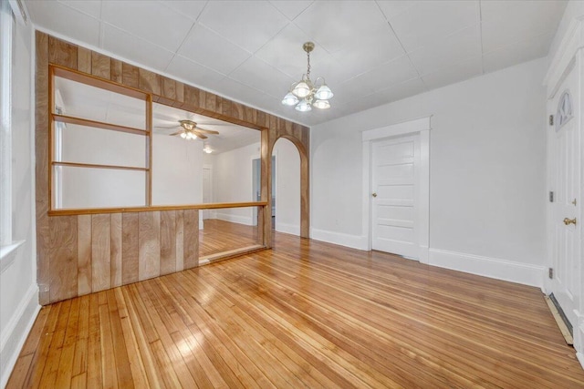 1132 Montrose Ave SE, Roanoke, VA 24013 - spare room with arched walkways, light wood finished floors, a chandelier, and baseboards