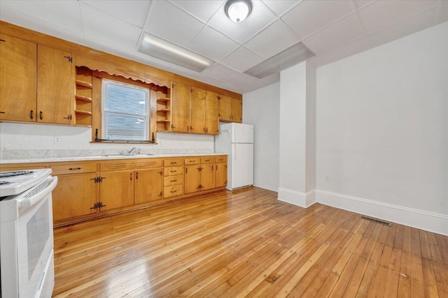1132 Montrose Ave SE, Roanoke, VA 24013 - kitchen with open shelves, white appliances, a sink, and light wood-style floors