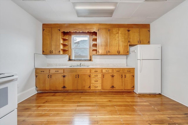 1132 Montrose Ave SE, Roanoke, VA 24013 - kitchen with white appliances, open shelves, a sink, light countertops, and light wood-style flooring