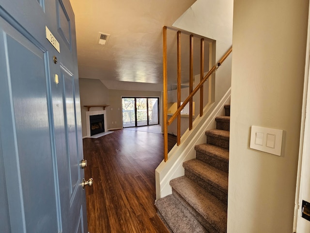 stairway featuring hardwood / wood-style floors