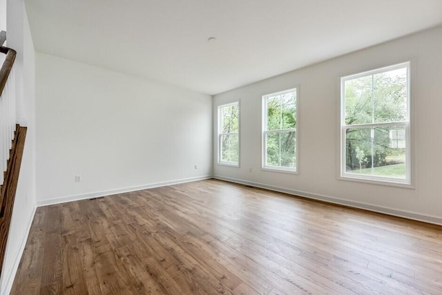 spare room with light hardwood / wood-style flooring