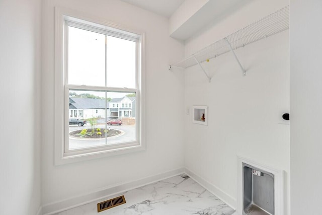 laundry area featuring washer hookup and a wealth of natural light