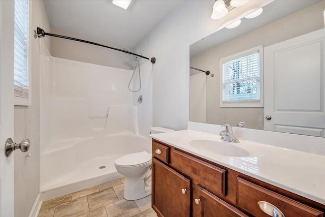 bathroom with toilet, a shower, and vanity