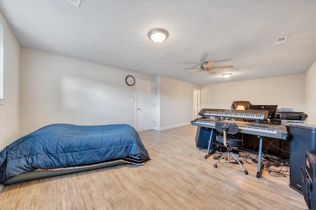 bedroom with light wood-type flooring and ceiling fan