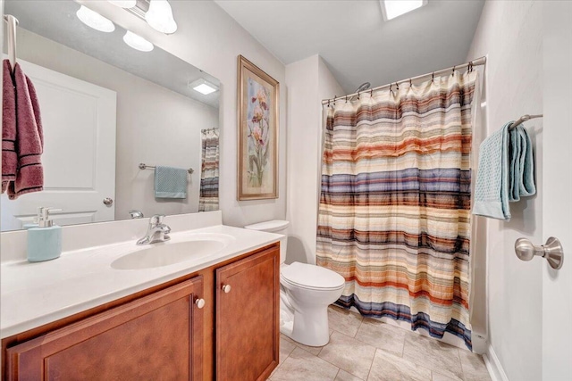 bathroom featuring toilet, tile patterned floors, walk in shower, and vanity