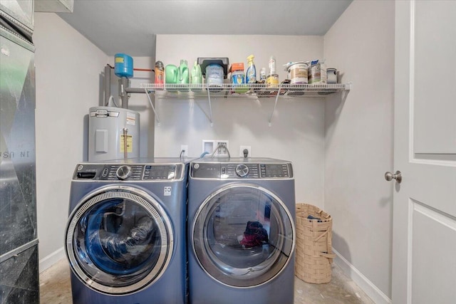 washroom featuring water heater and washing machine and clothes dryer