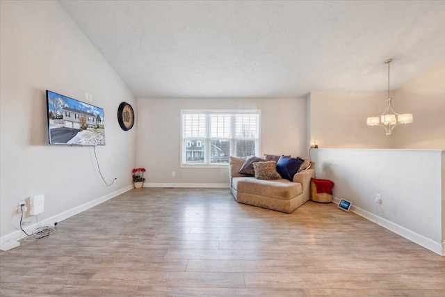 sitting room with light wood-type flooring and a notable chandelier