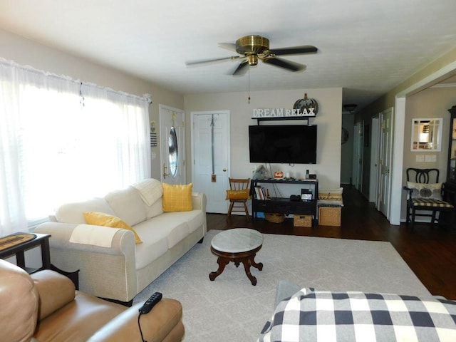 living room with ceiling fan and dark hardwood / wood-style floors