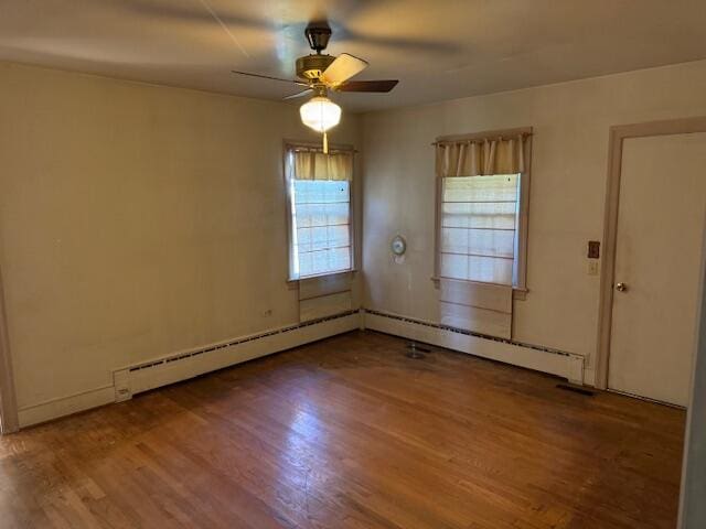 spare room with a baseboard radiator, hardwood / wood-style flooring, and ceiling fan