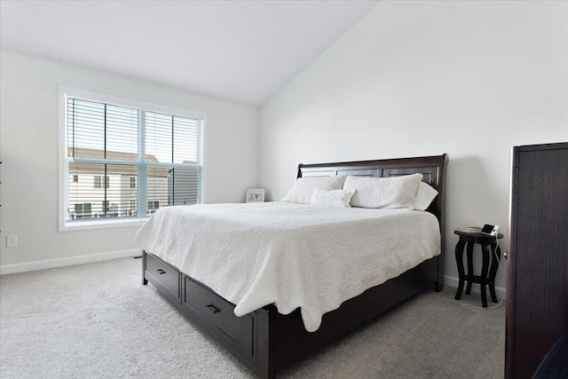 bedroom featuring light carpet and lofted ceiling