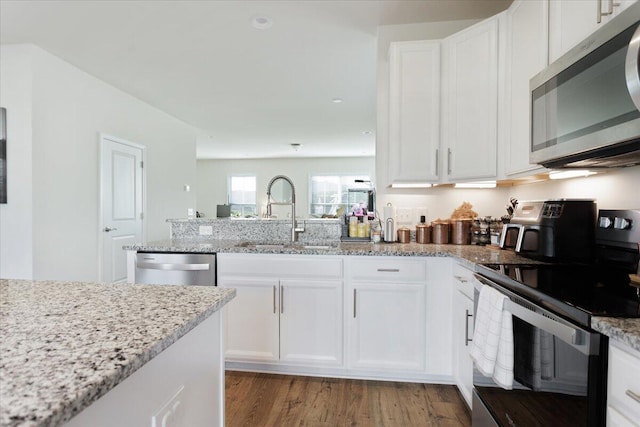 kitchen featuring white cabinetry, light hardwood / wood-style floors, appliances with stainless steel finishes, and sink