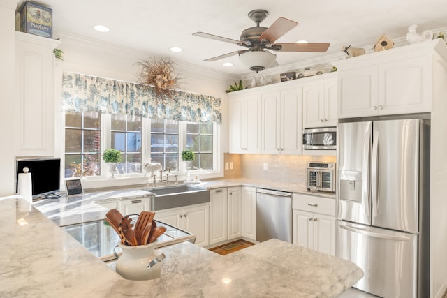 kitchen with crown molding, appliances with stainless steel finishes, and white cabinetry