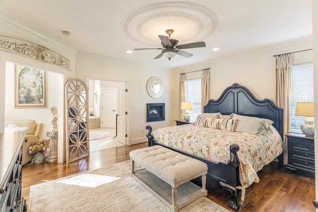 bedroom featuring ornamental molding, dark hardwood / wood-style floors, and ceiling fan