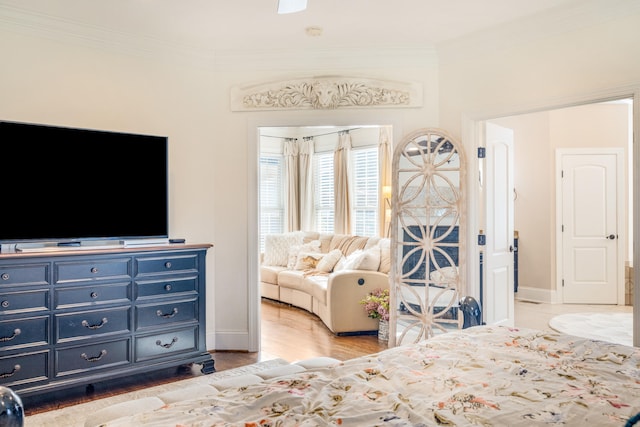 bedroom featuring crown molding and hardwood / wood-style flooring