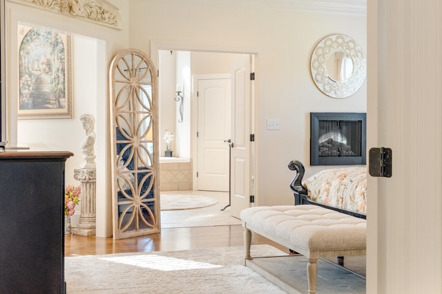 sitting room featuring light hardwood / wood-style floors and crown molding