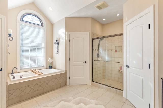 bathroom featuring tile patterned flooring, separate shower and tub, and vaulted ceiling