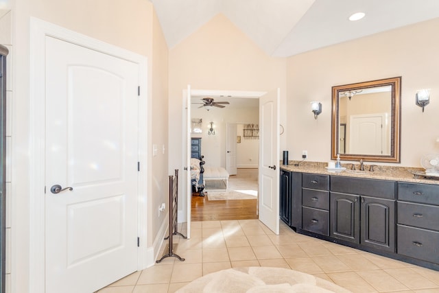 bathroom with vanity, ceiling fan, tile patterned floors, and vaulted ceiling