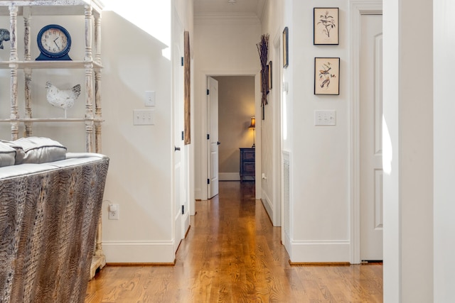 hallway featuring crown molding and wood-type flooring