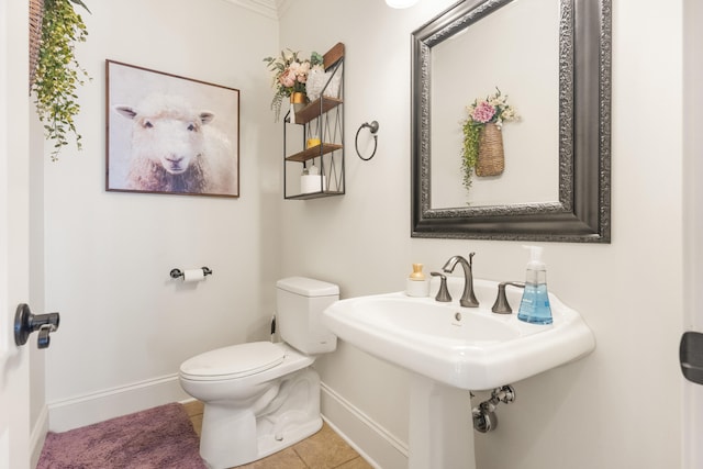 bathroom with toilet and tile patterned flooring