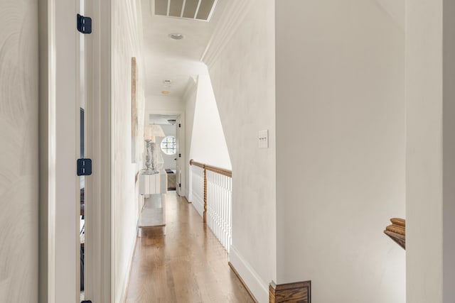 hall with ornamental molding and hardwood / wood-style flooring