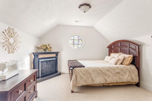 carpeted bedroom with vaulted ceiling