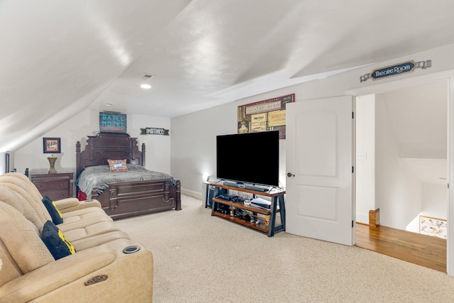 carpeted bedroom featuring lofted ceiling