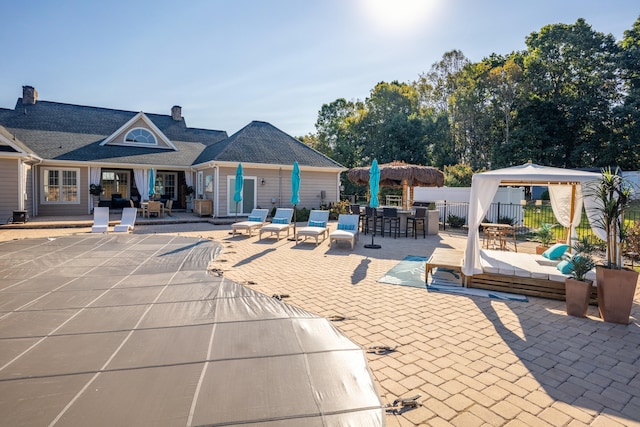 view of swimming pool with a patio area and exterior bar