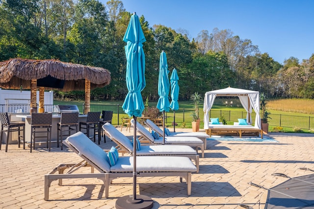 view of patio / terrace with a gazebo, an outdoor hangout area, area for grilling, and an outdoor bar