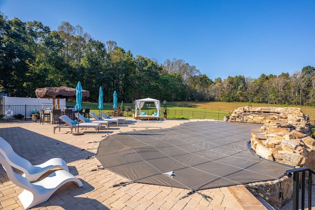 view of swimming pool with a patio area and a lawn