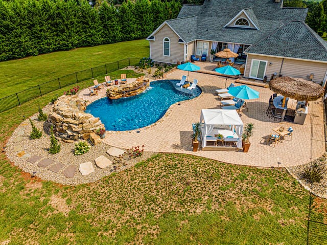 view of swimming pool featuring a yard and a patio area