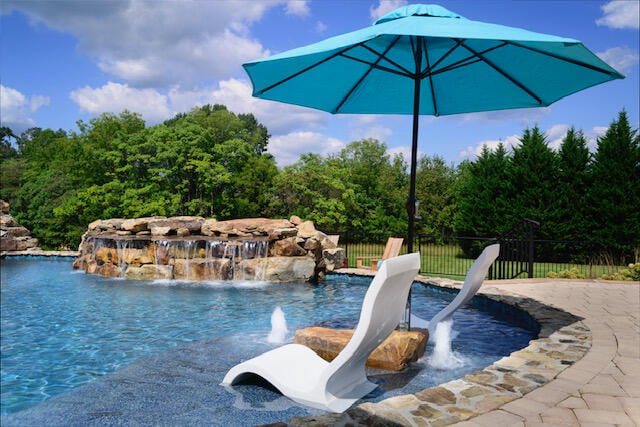 view of pool with a water slide and pool water feature