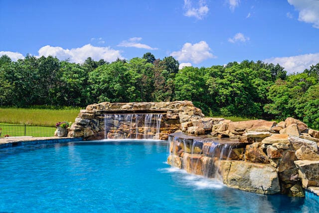 view of swimming pool with pool water feature