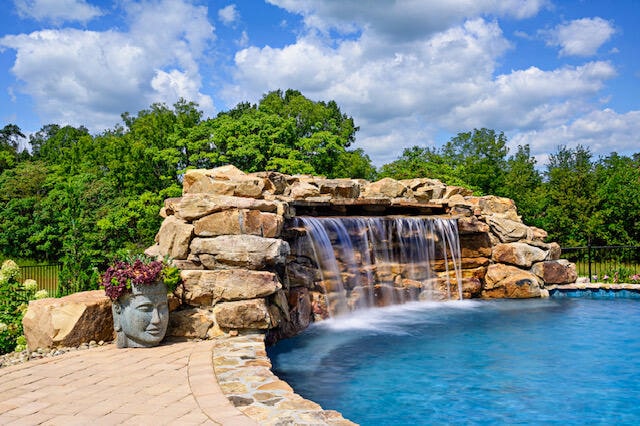 view of pool with pool water feature