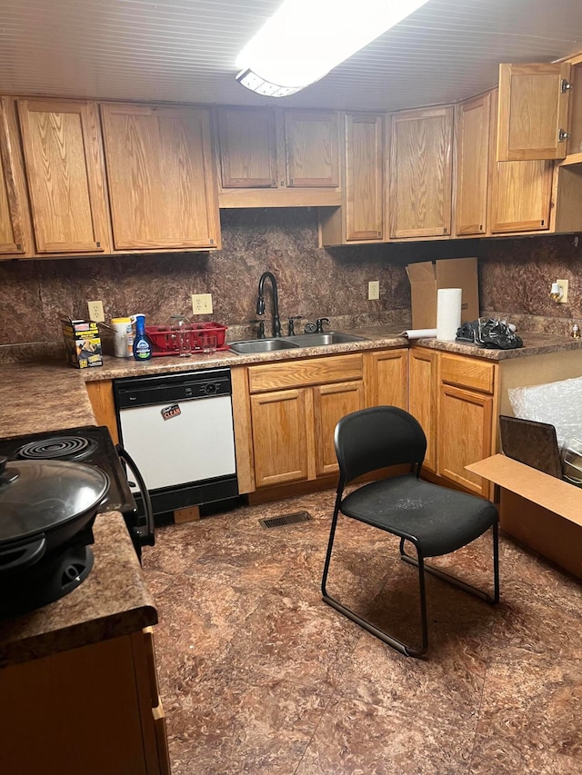 kitchen with dishwasher, sink, and backsplash