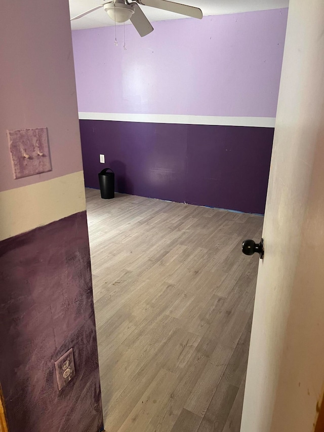 spare room featuring wood-type flooring and ceiling fan