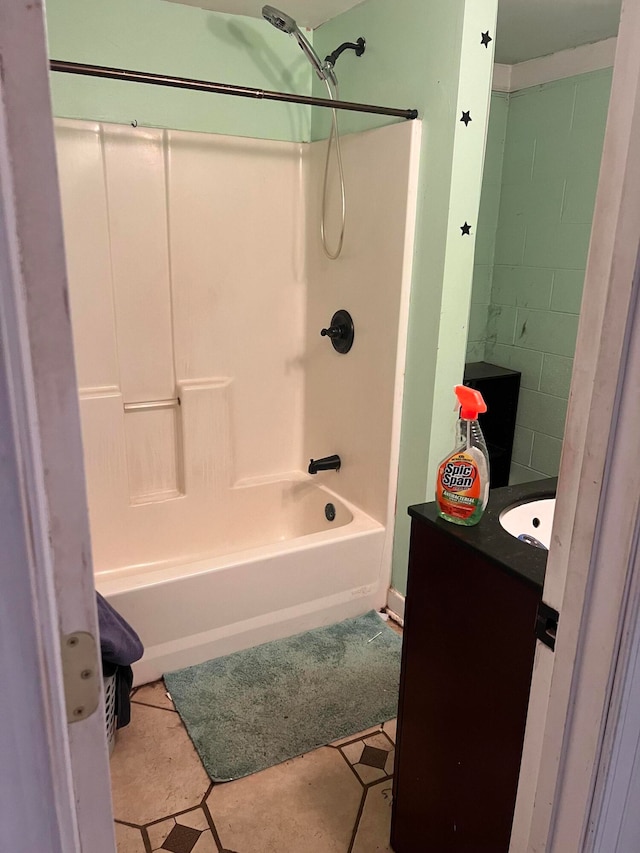 bathroom featuring vanity, tiled shower / bath combo, and tile patterned floors