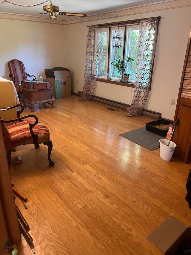 sitting room with ceiling fan and light hardwood / wood-style flooring