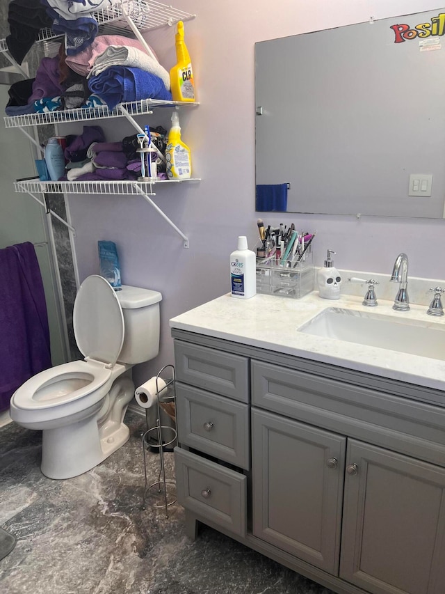 bathroom featuring vanity and toilet