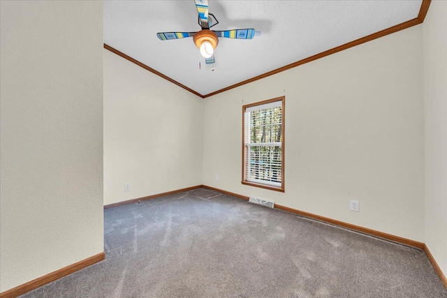 empty room featuring carpet flooring, ceiling fan, and crown molding