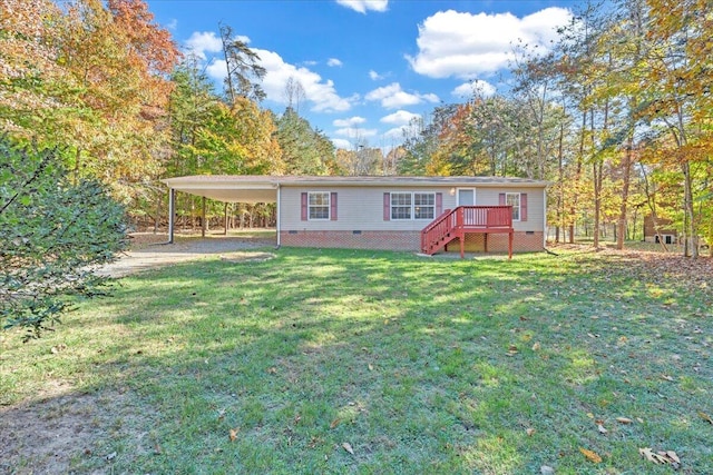 rear view of house featuring a yard, a deck, and a carport