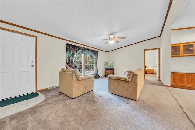 carpeted living room with a textured ceiling, ceiling fan, and ornamental molding