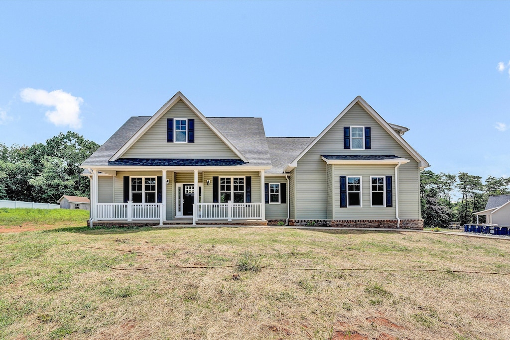 view of front of property with a front yard and a porch