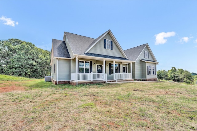 view of front of house with covered porch, a front lawn, and central AC unit