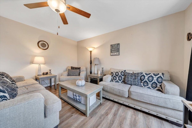 living room with ceiling fan and light hardwood / wood-style floors