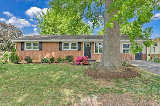 ranch-style house with brick siding and a front lawn