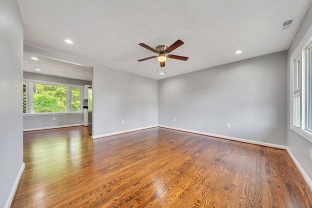 spare room featuring a ceiling fan, baseboards, and wood finished floors