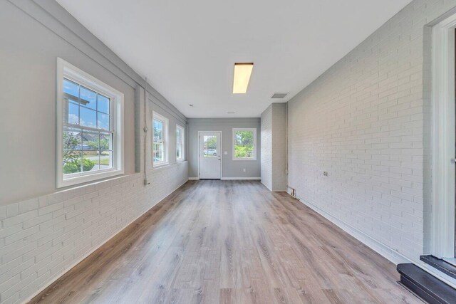 unfurnished sunroom featuring visible vents