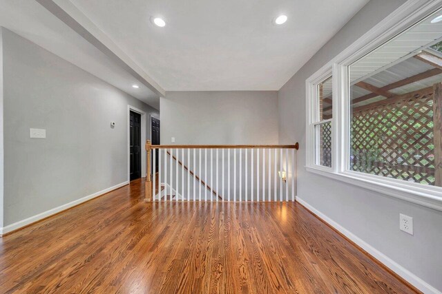 unfurnished room with baseboards, recessed lighting, and wood finished floors